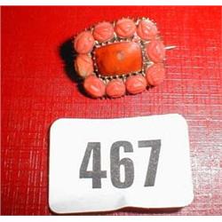 A gold and coral brooch