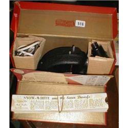 A c1930's "Mini Cine" projector together with a quantity of slide films - Snow White, Enid Blyton et