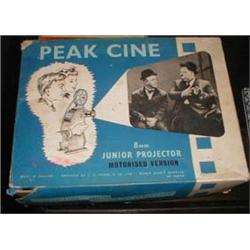 A 8mm Peak Cine tinplate film projector by J S Frieze & Co Ltd with films "Chasing the Bandits", "Th