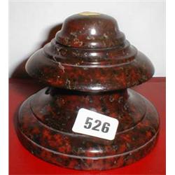 A large red serpentine inkwell with liner