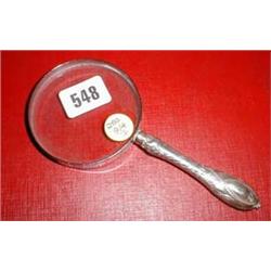 A silver handled magnifying glass