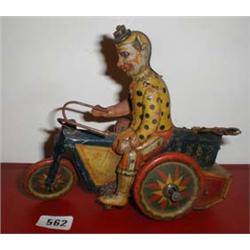 A c1920's tin-plate clown on a chain-driven motor bike by " D R P a" Germany