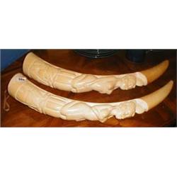 A pair of carved ivory tusks