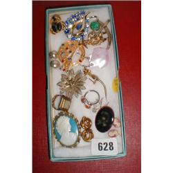 A box of costume jewelry including brooches, pendants etc