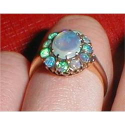 A large 9ct gold opal dress ring surrounded by 11 smaller opals