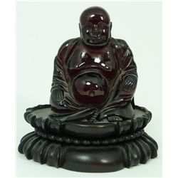 CHINESE CARVED BLOOD AMBER SEATED BUDDHA