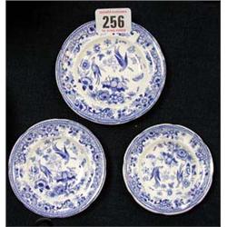 Three miniature, graduated blue and white plates.