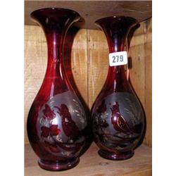 A pair of early red glass vases with bird decoration.