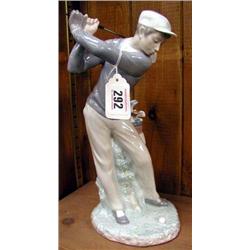 A large Lladro figure of a golfer.