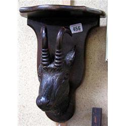 A carved Black forest wall bracket in the form of a goat's head.