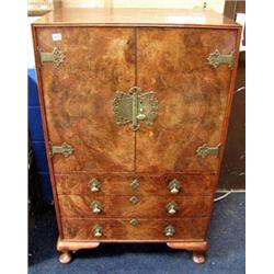 A superb quality burr Walnut tall boy/cabinet with ornate Brass fittings, the two panel doors reveal