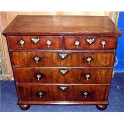 An 18thC mahogany chest of two short and three graduated long drawers with feather banding, having b