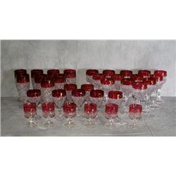 34 pieces of cranberry and clear cut glass cups of