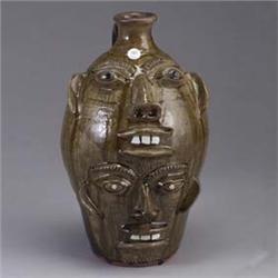 WALTER FLEMING double face jug covered in a green alkaline glaze on front, and brown glaze on back.