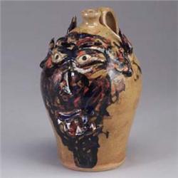 DWAYNE CRAIG face jug with cobalt, black, and orange decoration against a tan ground. Signed Dwayne