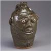 Image 1 : A.G. MEADERS face jug, 1990, incised with expressive eyebrows and eyelashes, and covered in a drippi