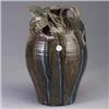 Image 1 : Tall J. FLOWERS stoneware jug, 1997, with large applied dragon, covered in pink, blue, and green dri