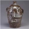Image 1 : LOUIS BROWN face jug, Arden N.C., covered in a mottled umber and ivory glaze. Incised Brown's Potter