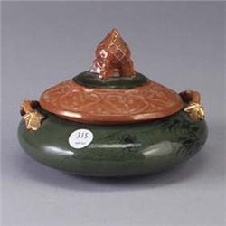 MATT MORGAN covered jar with base decorated with spiders and webs on a green ground, with vinescroll