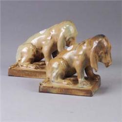 Pair of French figural bookends with hounds covered a butterscotch flambe glaze. One has chips to ba
