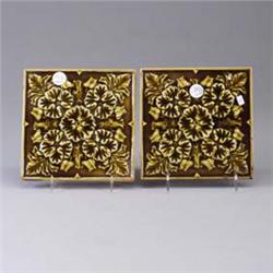 Two ENCAUSTIC TILE CO. tiles embossed with stylized floral motif under a sheer umber glossy glaze. S