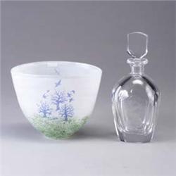 Two glass pieces; a KOSTA BODA bowl with birds and trees, and a ORREFORS bottle with stopper, etched