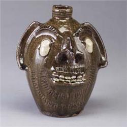 STEVE ABEE, Lenoir, N.C., bearded face jug with oozing white eyes and pointed nose. Incised mark. 9"
