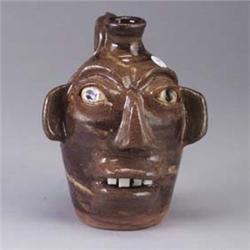 B.B.CRAIG face jug of swirled brown, green, and white clays. 1/4" chip to base and burst bubble to b