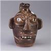 Image 1 : B.B.CRAIG face jug of swirled brown, green, and white clays. 1/4" chip to base and burst bubble to b