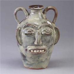 WPF two-handled face jug covered in a sheer mottled ivory glaze. Etched mark. 10" Est.  450 - 650