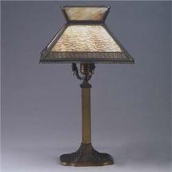 Arts & Crafts brass table lamp with flaring shade with Greek key pattern and caramel slag glass, on