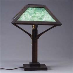 Arts & Crafts table lamp with flaring, four-sided shade inset with green slag glass panels, on a squ