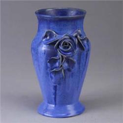 FULPER vase covered in a bright blue flambe glaze, and decorated with an applied rose. Minor grindin