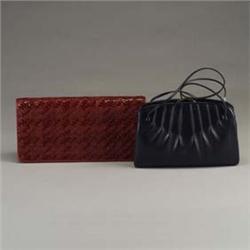 Two JUDITH LEIBER purses: one in navy leather with pleated sides and semi-circular clasp including m