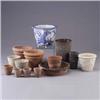 Image 1 : Fifteen assorted pieces; two ceramic planters, three metal planters, nine terra cotta planters, and