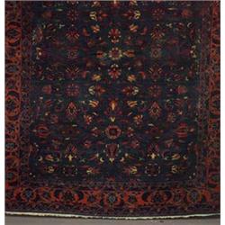Persian room-size rug with overall floral polychrome pattern on a hunter green ground within multipl