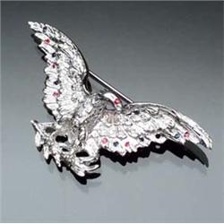 18-Karat White Gold, Diamond, Blue Sapphire and Ruby Eagle Brooch Set with twenty-six round brill...