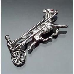 18-Karat White Gold and Diamond Trotter Pin The horse's eye set with one round faceted ruby weigh...