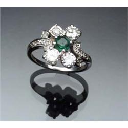 Platinum, Emerald and Diamond Dinner Ring Circa 1950 Set with one octagonal square cut emerald we...