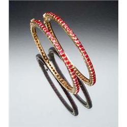 Pair of Indian 22-Karat Yellow Gold and Ruby Bangle Bracelets Each set with sixty-five round face...
