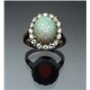 Image 1 : 14-Karat Yellow and White Gold, Opal and Diamond Dinner Ring Circa 1950 Set with an oval cabochon...