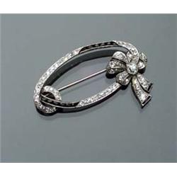 Art Deco Platinum, Diamond and Black Onyx Brooch Circa 1920-1930 Set with sixty old mine and sing...