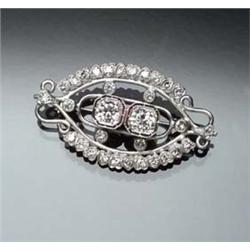 Tested Palladium, Platinum and Diamond Brooch Set with two large round old European cut diamonds...