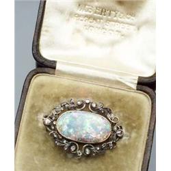 Victorian Tested 14-Karat Yellow Gold, Black Opal and Diamond Brooch Circa 1880 Set with an oval...