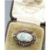 Image 1 : Victorian Tested 14-Karat Yellow Gold, Black Opal and Diamond Brooch Circa 1880 Set with an oval...