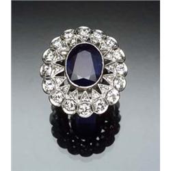 Edwardian Platinum, Blue Sapphire and Diamond Cocktail Ring Circa 1910 Set with an oval faceted s...
