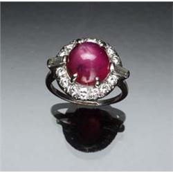 Art Deco Platinum, Star Ruby and Diamond Dinner Ring Circa 1930 Set with one round cabochon star...