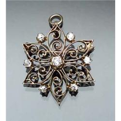 Tested 14-Karat Yellow Gold and Diamond Star Pendant Brooch Circa 1910 Set with one old mine cut...