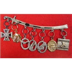 MINIATURE GERMAN NAZI CHARMS ATTACHED TO SWORD PIN
