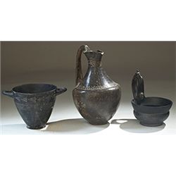 Vases. Three etruscan vessels. Circa 7th - 6th century BC.  D/ Bucchero-ware kyathos, with a female-